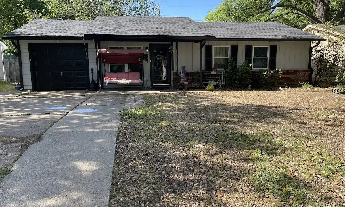 Wind Damage Roof Repair crew at work on a residential roof in Bastrop